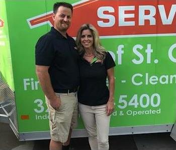 The owners at SERVPRO of St. Cloud standing in front of the SERVPRO of St. Cloud trailer. 