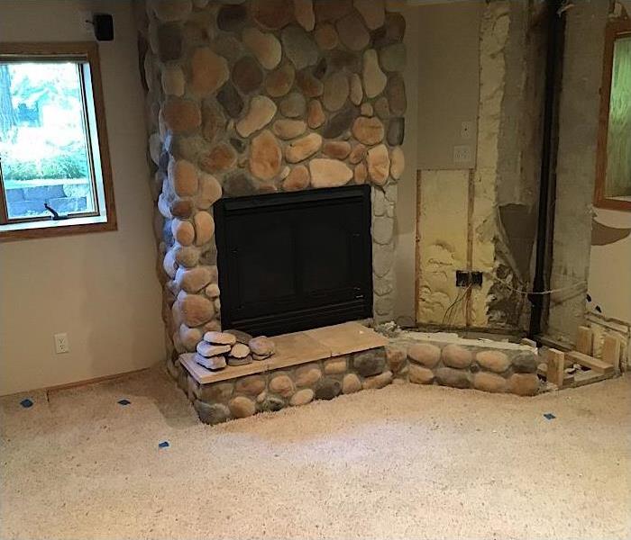 Rock fire place and tv stand tore out due to water damage.