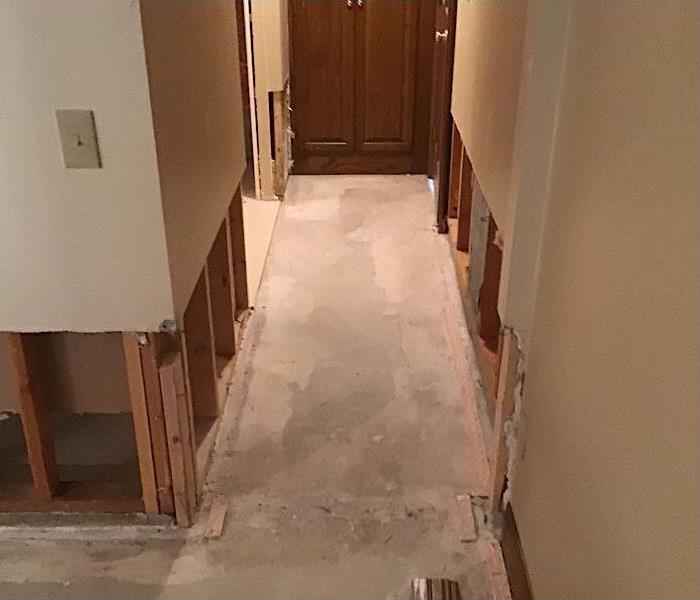 Hallway with the bottom foot cut out due to water damage. 