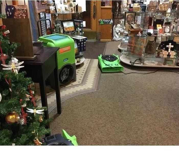 Inside a store with SERVPRO green equipment.